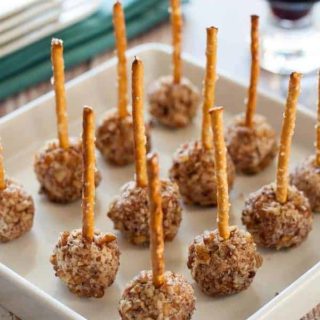 Mini Goat Cheese Balls on a Stick. Holiday party food for any time of the year. Tiny bites of goat cheese, pecorino cheese, dried cranberries and pecans, skewered with a pretzel. |www.flavourandsavour.com