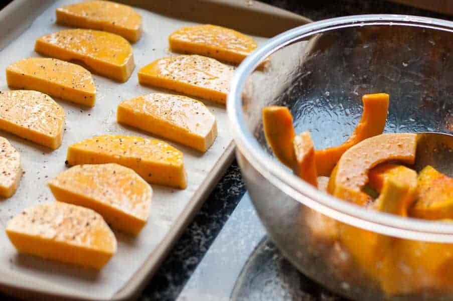 Honey-Lime Glazed Butternut Squash with Fresh Rosemary on a baking sheet. |www.flavourandsavour.com