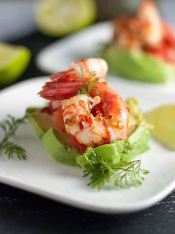 Grilled Chili Lime Shrimp with Fresh Salsa. Easy but impressive appetizer, easily assembled on sliced avocado with a dollop of fresh salsa.