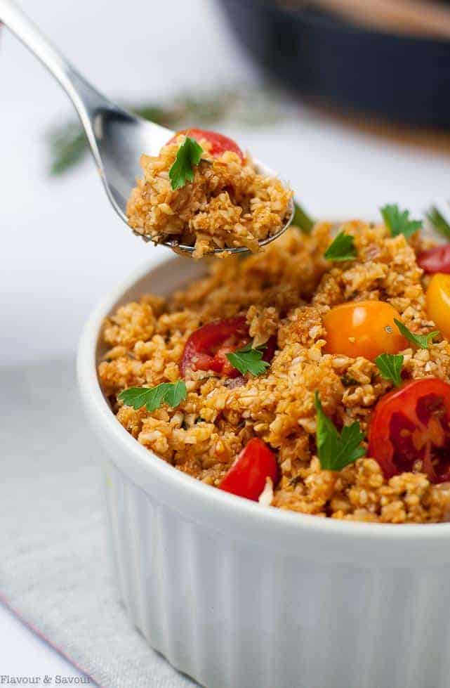 A spoonful from a bowl of cauliflower rice.