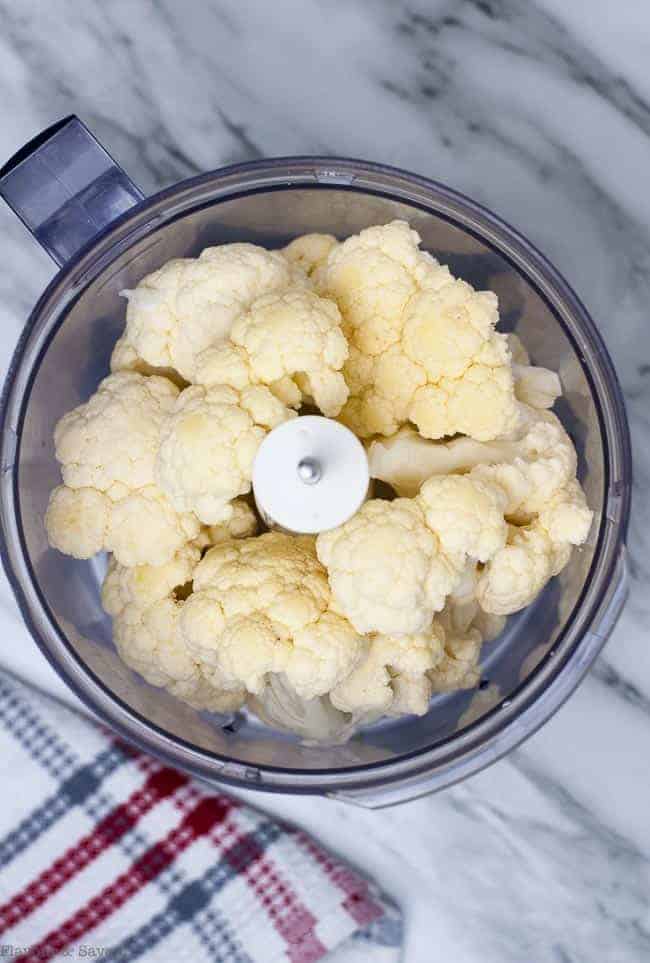 3 easy steps to make Cauliflower Rice. Put florets in food processor.