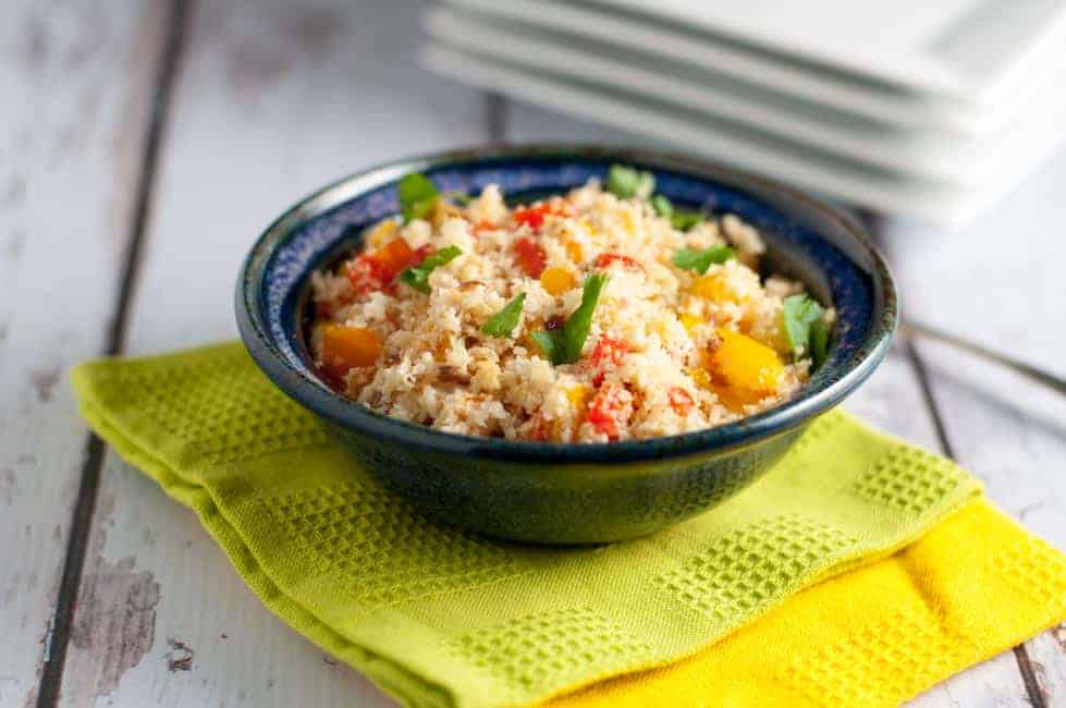 3 Easy Steps to Make Cauliflower Rice. Cauliflower rice with veggies in a blue pottery bowl.