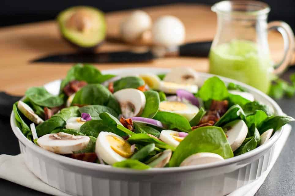 Classic Spinach Salad with Creamy Avocado Dressing. Love spinach salad but hate the high-fat buttermilk dressing? Try this updated paleo spinach salad with creamy dairy-free avocado dressing. One of 6 Tasty Healthy Winter Salads from Flavour and Savour.