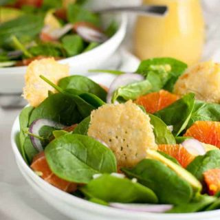 Orange and Avocado Salad with Parmesan Crisps. Sweet Cara Cara oranges, creamy avocados, fennel and red onion on a bed of fresh greens, garnished with crunch Parmesan crisps.