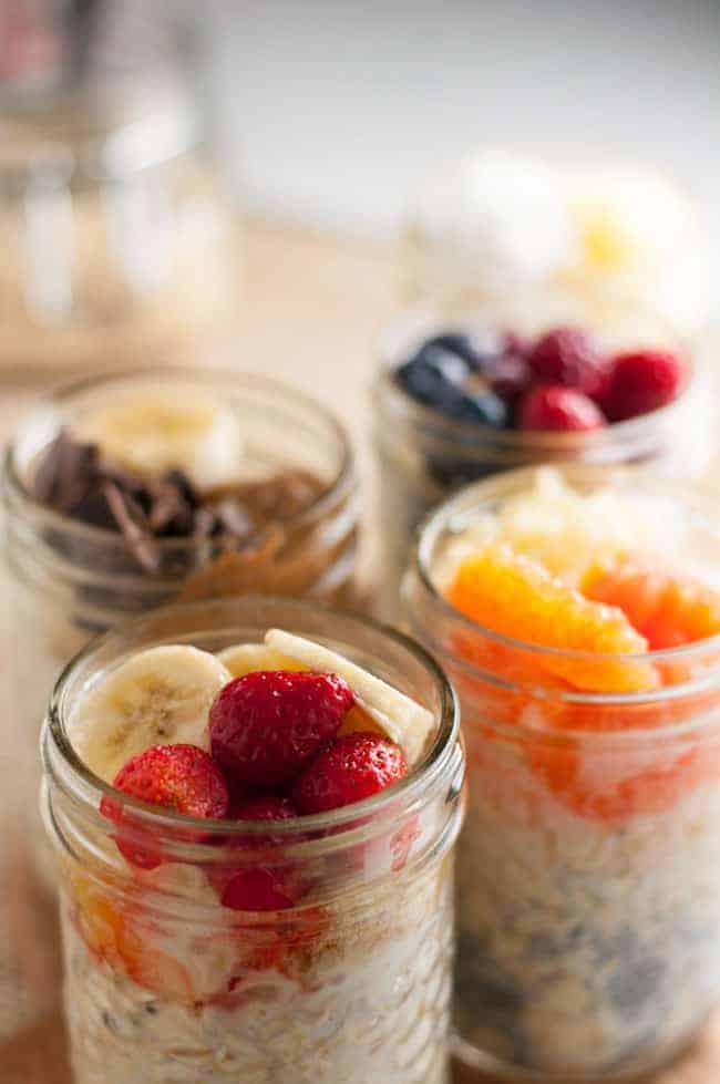 Small jars of overnight oats with different toppings.