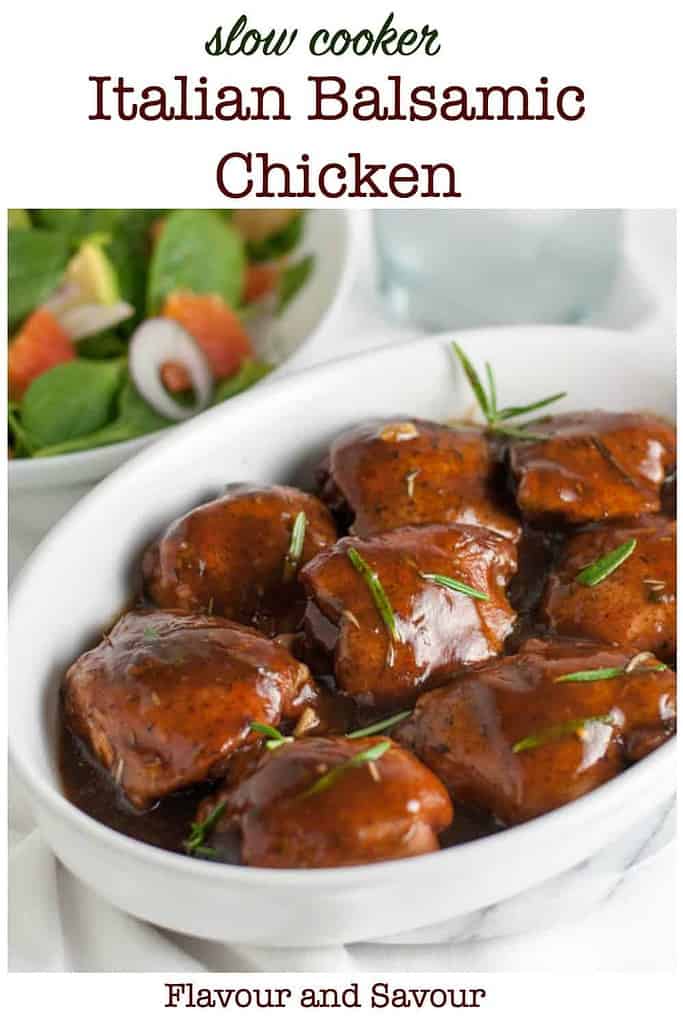 Slow Cooker Italian Balsamic Chicken in a bowl with a green salad and a glass of water