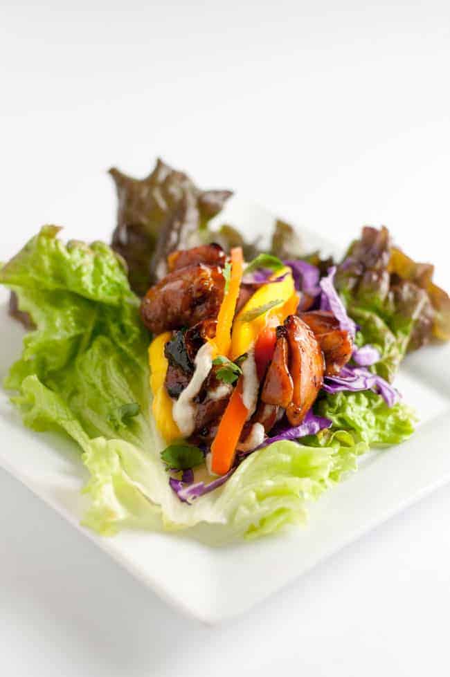 Thai Chicken Lettuce Wraps with Cashew Cream. Sweet and spicy chicken, peppers, mango, and crunchy cabbage all drizzled with a flavourful cashew cream makes a super dairy-free, gluten-free lunch or light dinner.