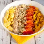 Tropical Turmeric Smoothie Bowl. A healthy way to start your day. Pineapple, orange and mango top a tropical turmeric smoothie. Loaded with Vitamin C and anti-inflammatory turmeric.