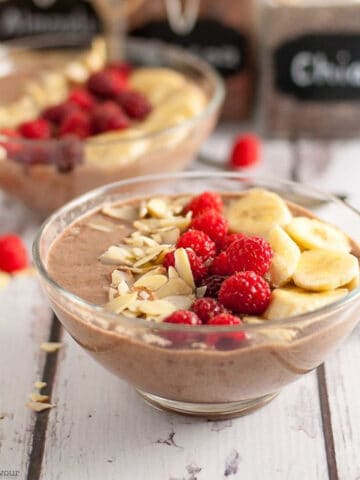 mocha almond smoothie bowl with raspberries and sliced bananas