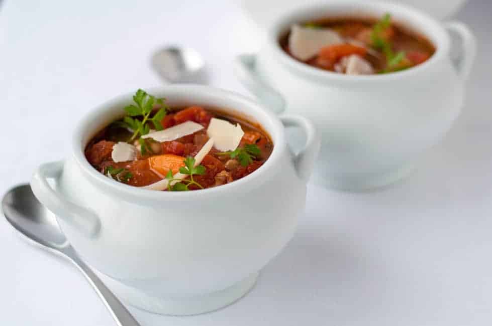 One-Pot Healthy and Hearty Tuscan Minestrone Soup in white soup tureens.