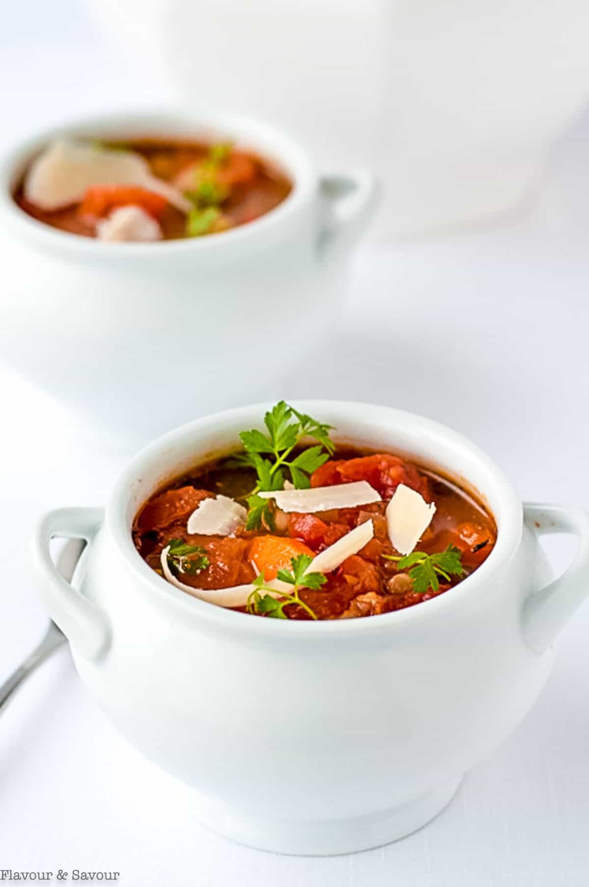 Two white bowls of Tuscan Minestrone Soup.
