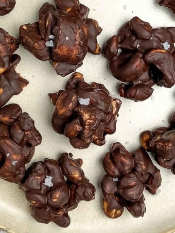 Chocolate cashew clusters on a plate.