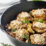 Baked Sun-dried Tomato and Artichoke Chicken thighs in cast iron skillet.