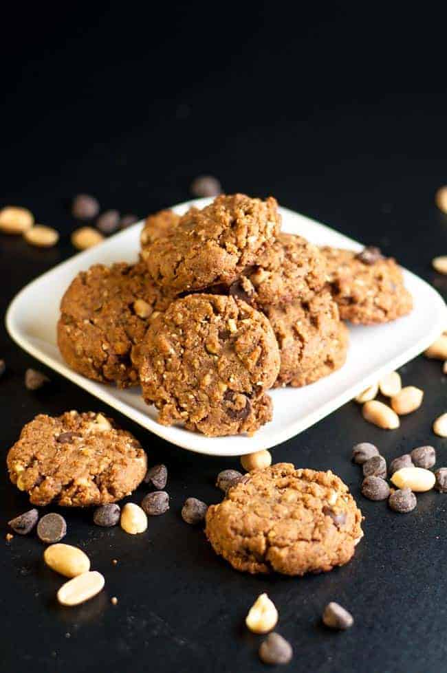 My Favourite Gluten-Free Peanut Butter Chocolate Cookies on a plate. This recipe makes a soft but sturdy flourless cookie with coconut palm sugar and added peanuts for crunch. Totally satisfying! 