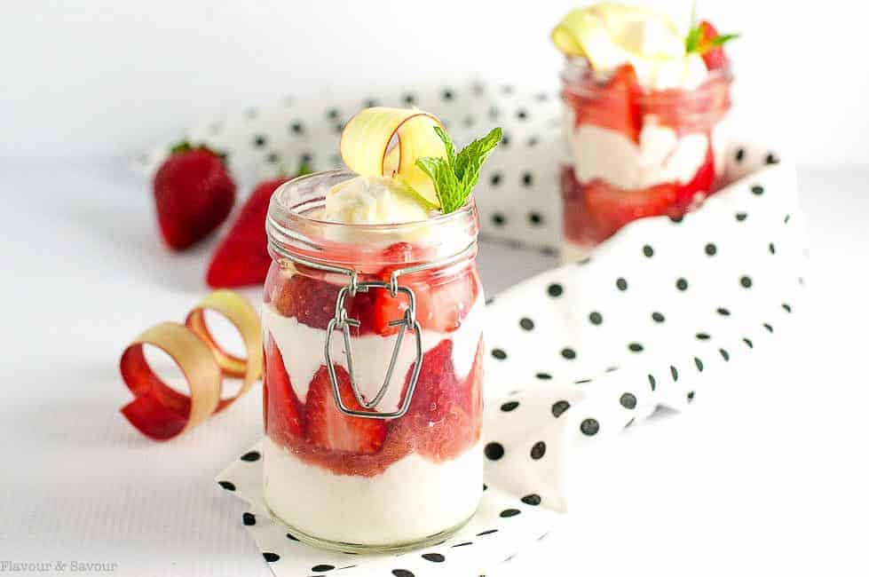 Skinny Strawberry Rhubarb Parfait in glass jars with a black and white polka dot napkin