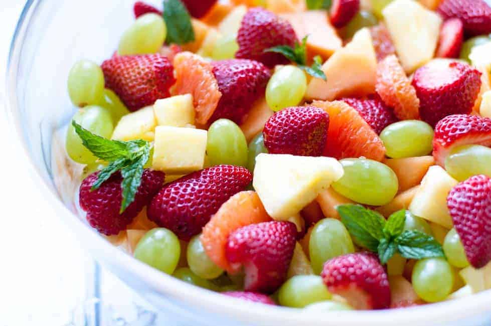 Tropical Fruit with Honey Mint Lime Syrup. Close up view of fruit in a large bowl.