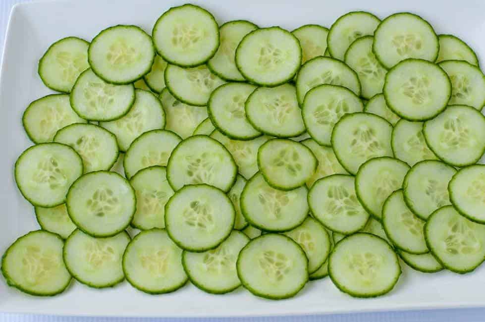 sliced cucumbers on a white platter