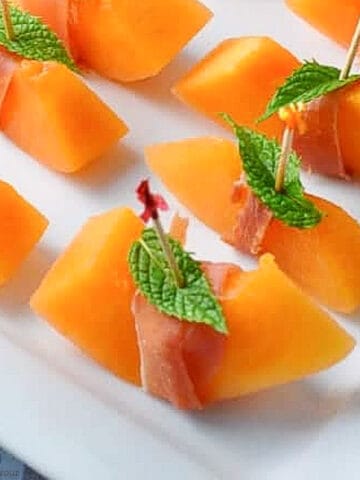 close up view of prosciutto wrapped melon