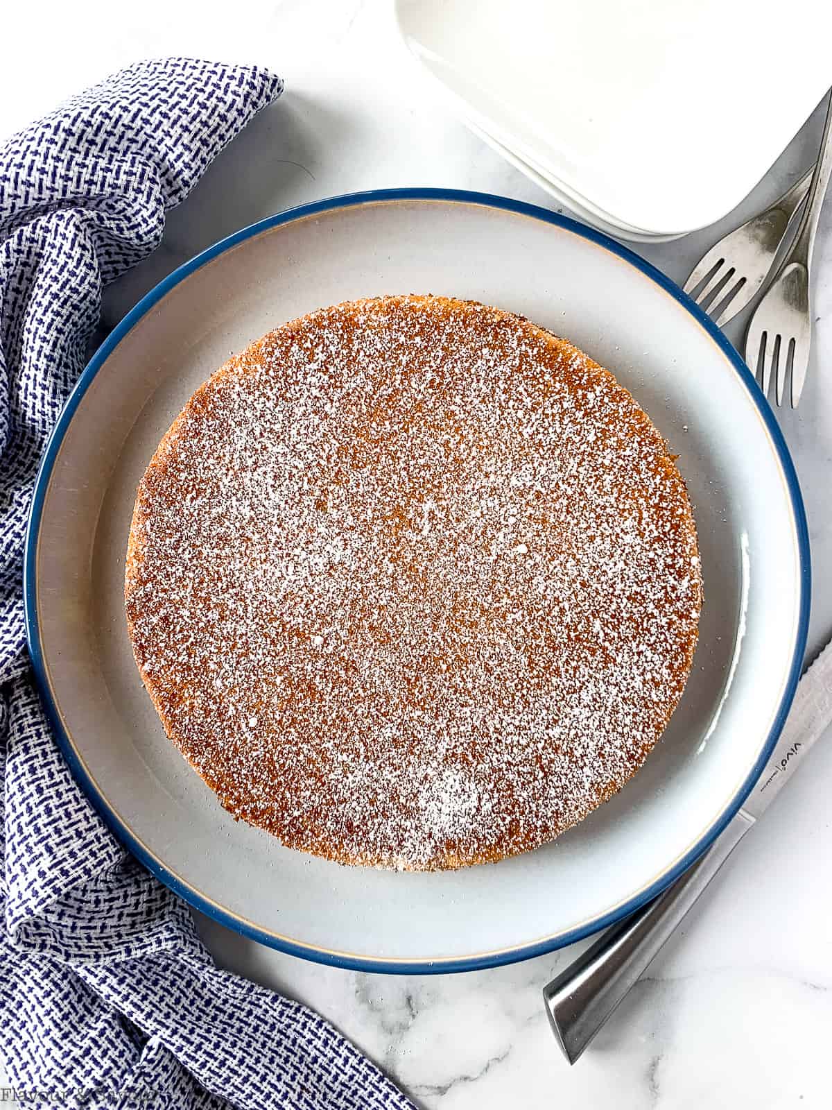 Baked lemon almond cake with powdered sugar on top.