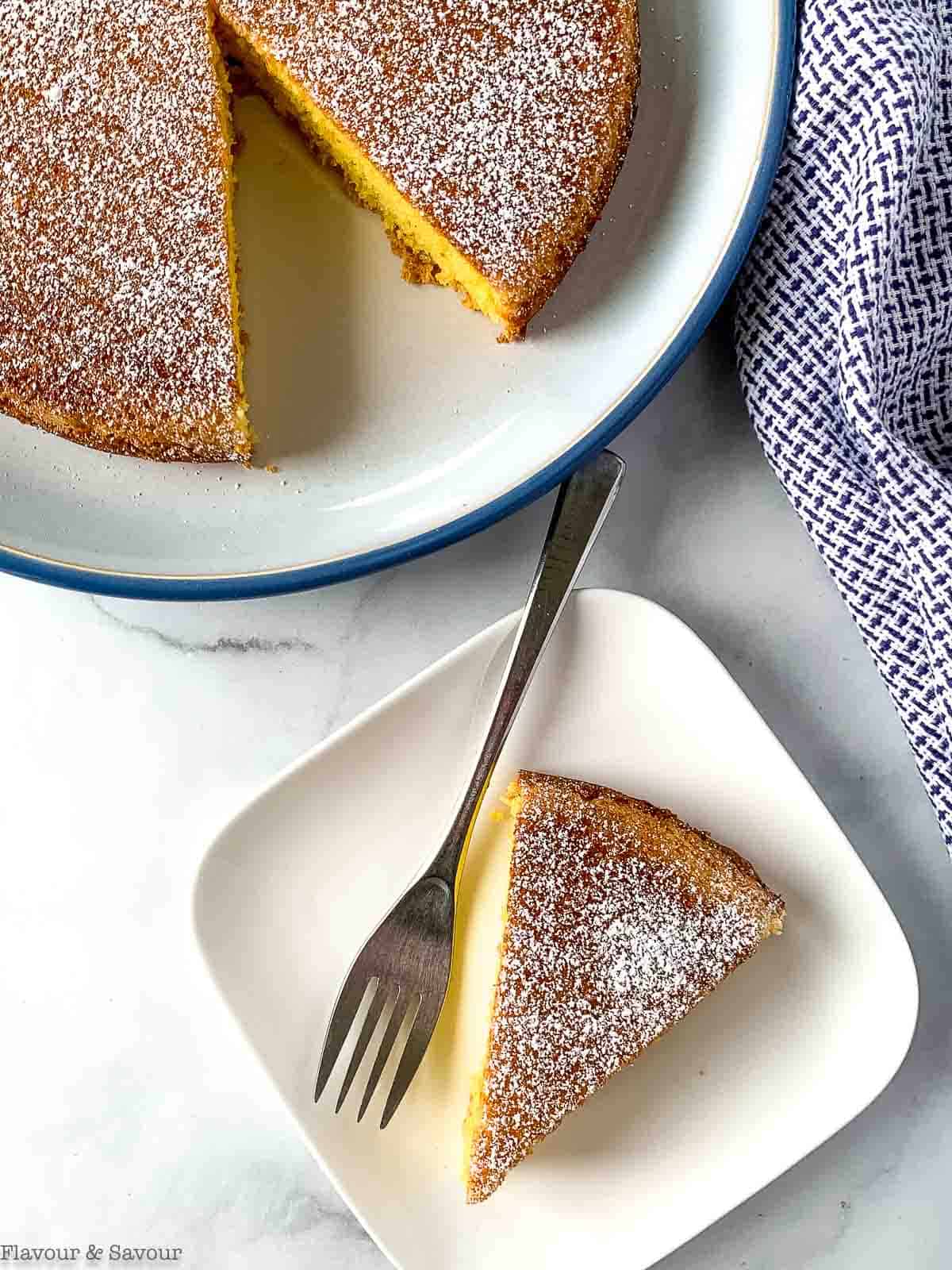 Overhead view of once bowl almond cake with powdered sugar topping.