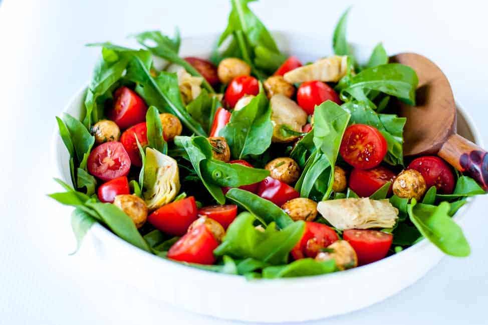 Balsamic Bocconcini Cherry Tomato Salad with Marinated Artichokes and Arugula. This vegetarian salad packs a punch of flavour. Peppery arugula , balsamic bocconcini balls, marinated artichokes and fresh cherry tomatoes combine to make a salad I could eat every day! |www.flavourandsavour.com