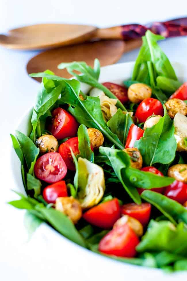 Balsamic Bocconcini Cherry Tomato Salad with Marinated Artichokes and Arugula. This vegetarian salad packs a punch of flavour. Peppery arugula , balsamic bocconcini balls , marinated artichokes and fresh cherry tomatoes combine to make a salad I could eat every day! |www.flavourandsavour.com