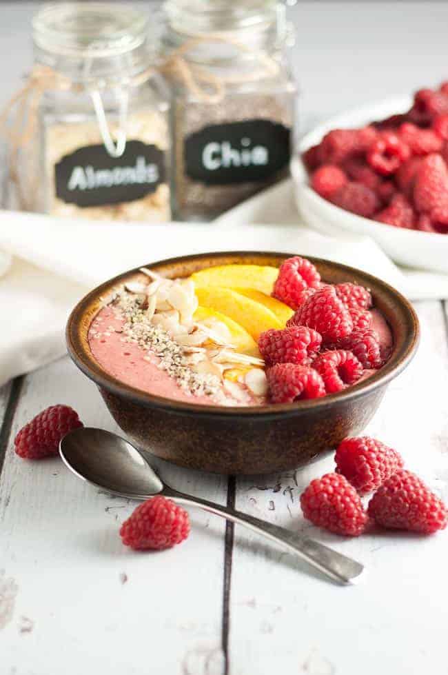 Healthy Peach Melba Breakfast Smoothie Bowl with fresh raspberries