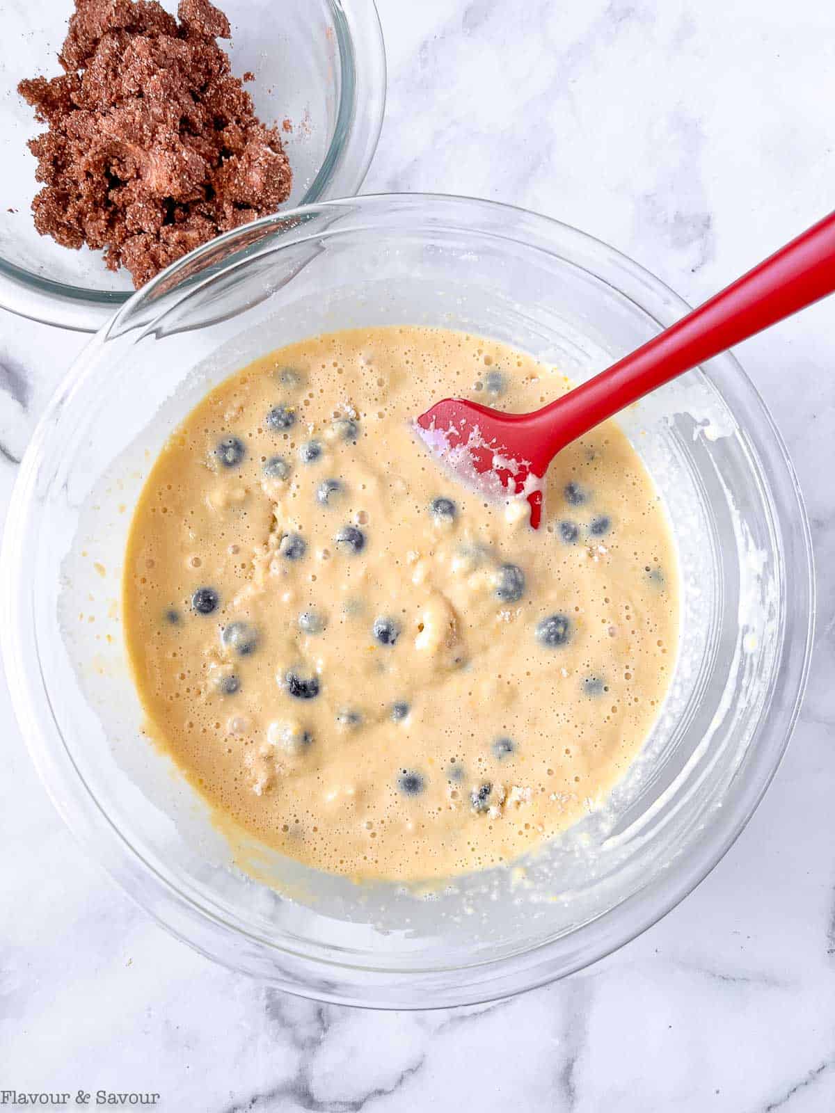 Combining ingredients to make gluten-free blueberry buckle.