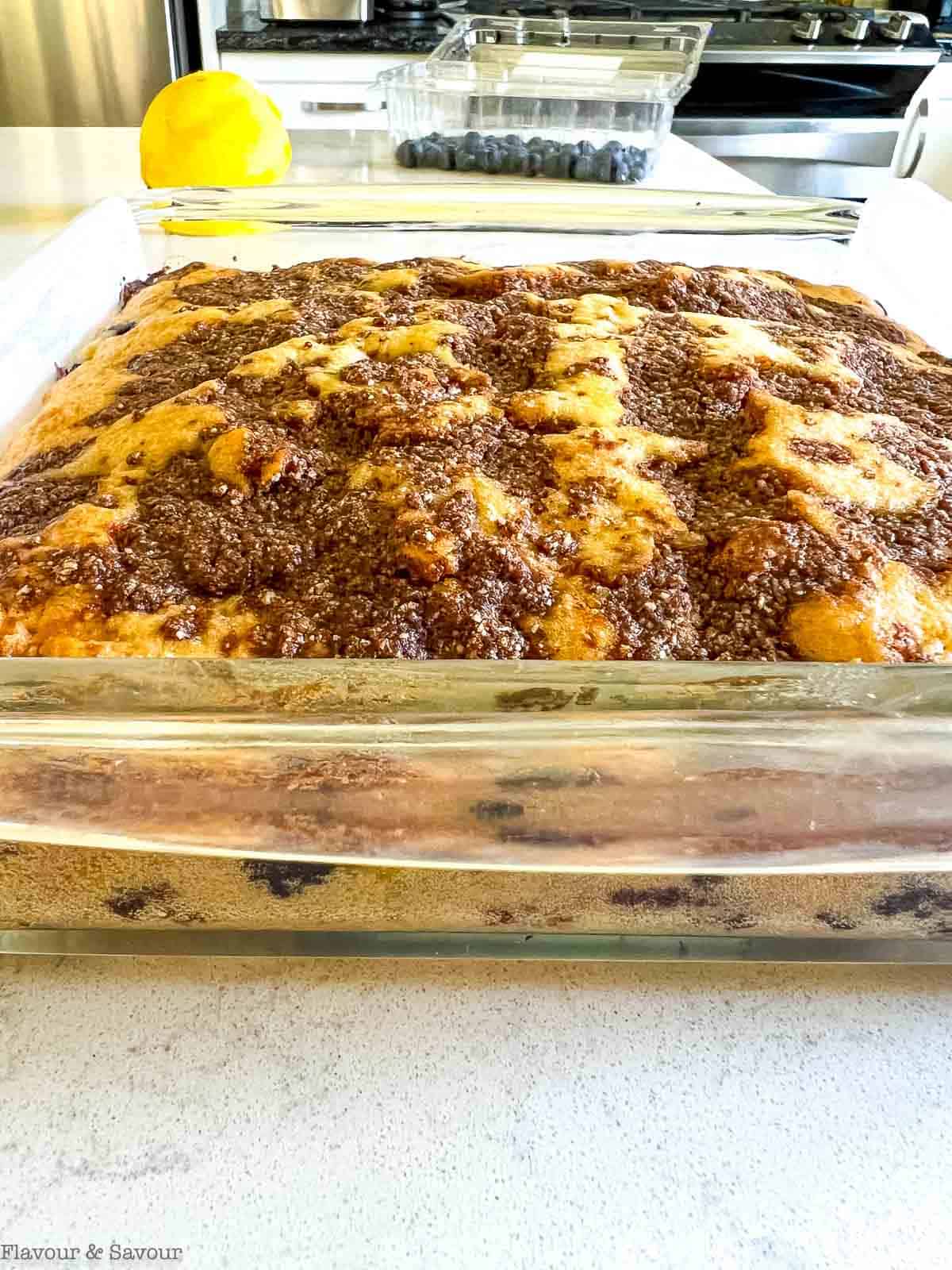 Blueberry lemon coffee cake in a glass baking dish on a counter.