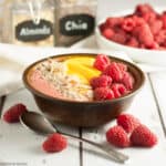 peach melba smoothie bowl with peaches and raspberries