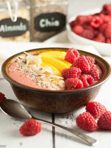 peach melba smoothie bowl with peaches and raspberries