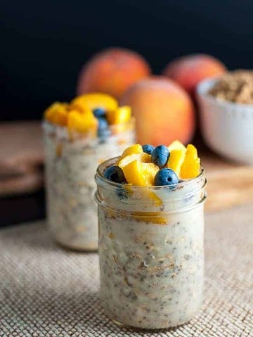 Peach and Blueberry Overnight Oats in two small jars..