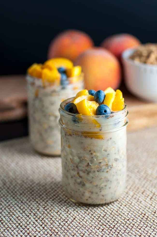 Peach and Blueberry Overnight Oats in two small jars..