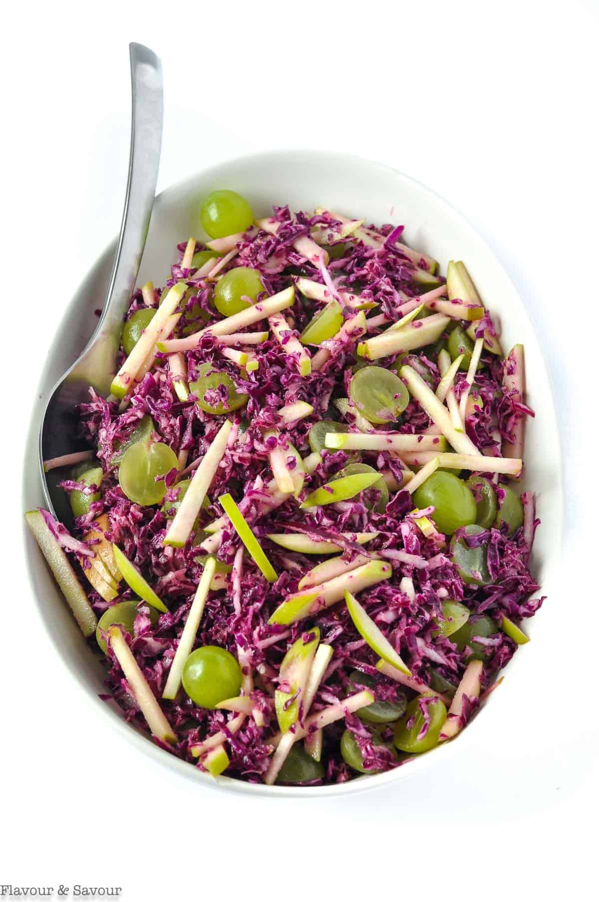 An oval bowl with Grape Apple and ?Red Cabbage Slaw