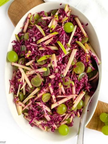 Overhead view of Grape Apple and Red Cabbage Slaw in an oval bowl