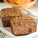 This Paleo Apple Cranberry Bread is tender and moist. It's topped with a naturally sweet glaze made from pecans, maple syrup and coconut oil. A healthy coffee-time snack! |www.flavourandsavour.com