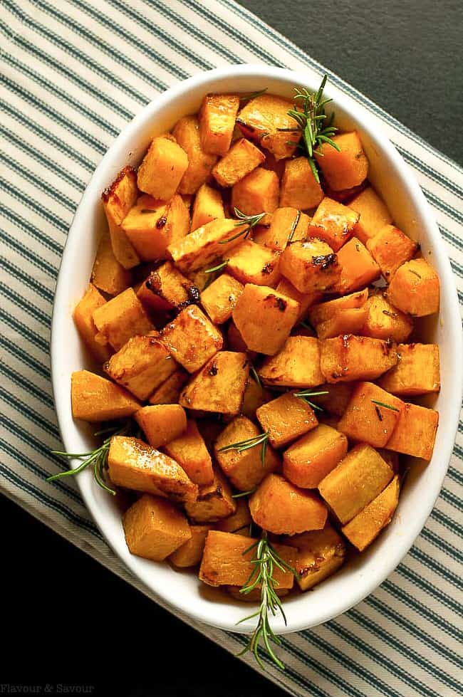 Overhead view of a white oval bowl filled with Roasted Butternut Squash