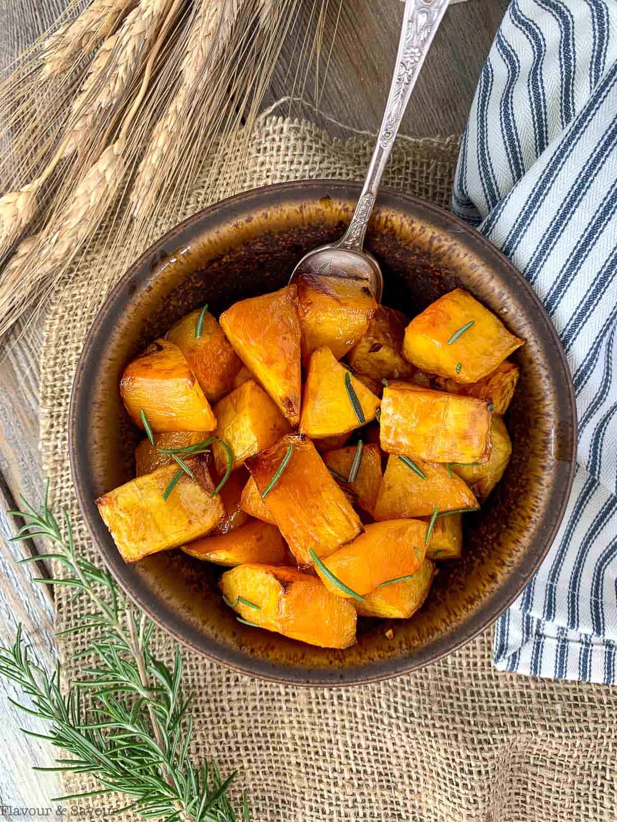 Overhead view of a bowl of Maple Dijon Roasted Butternut Squash with a spoon