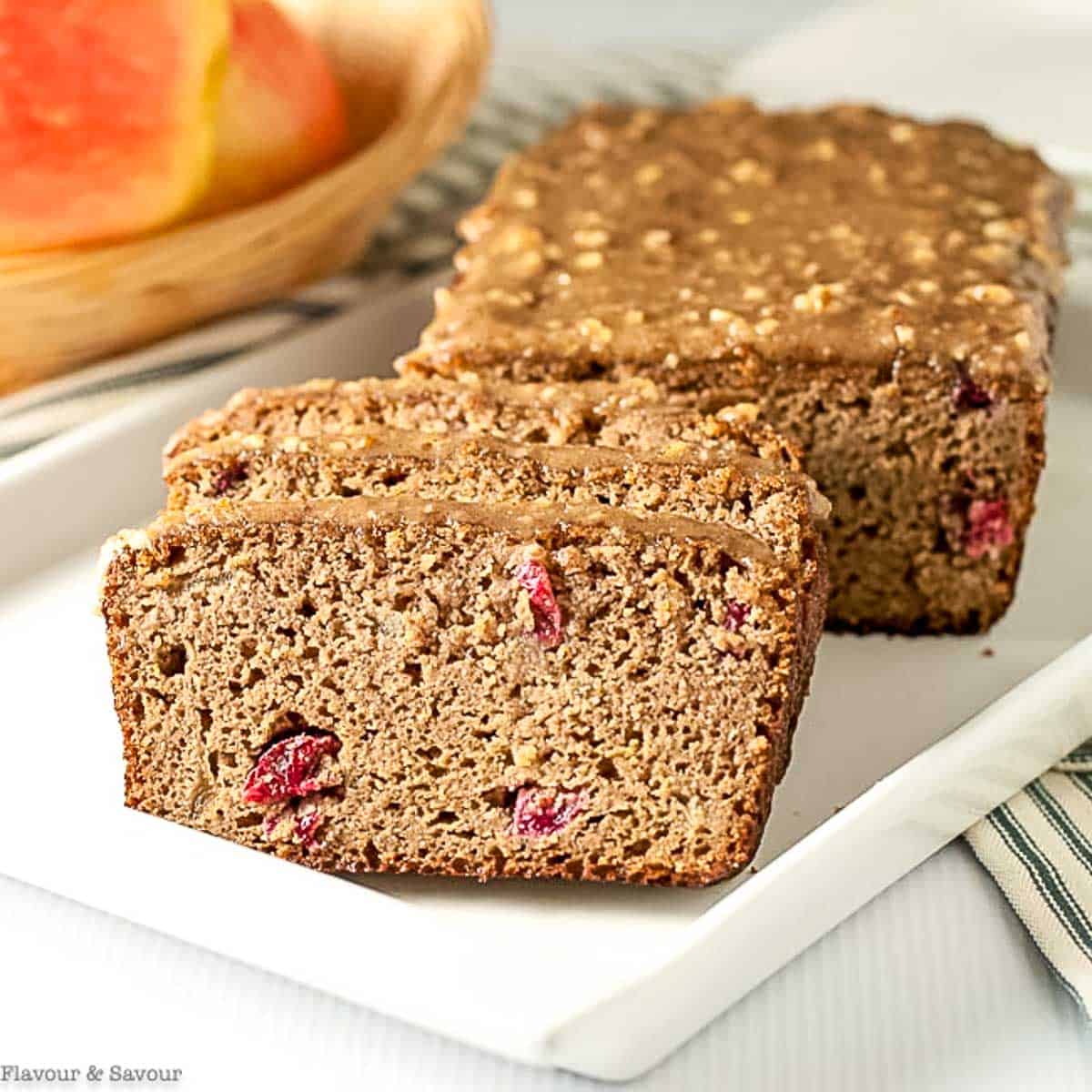 Slices of apple cranberry bread on a white plate.