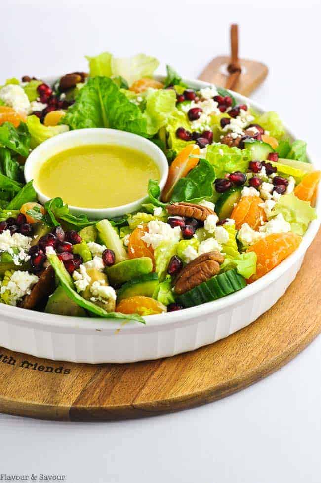 A healthy winter or Christmas salad in a round bowl shaped like a wreath