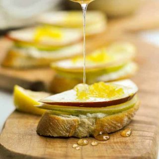 Drizzling honey on Blue Cheese and Pear Crostini
