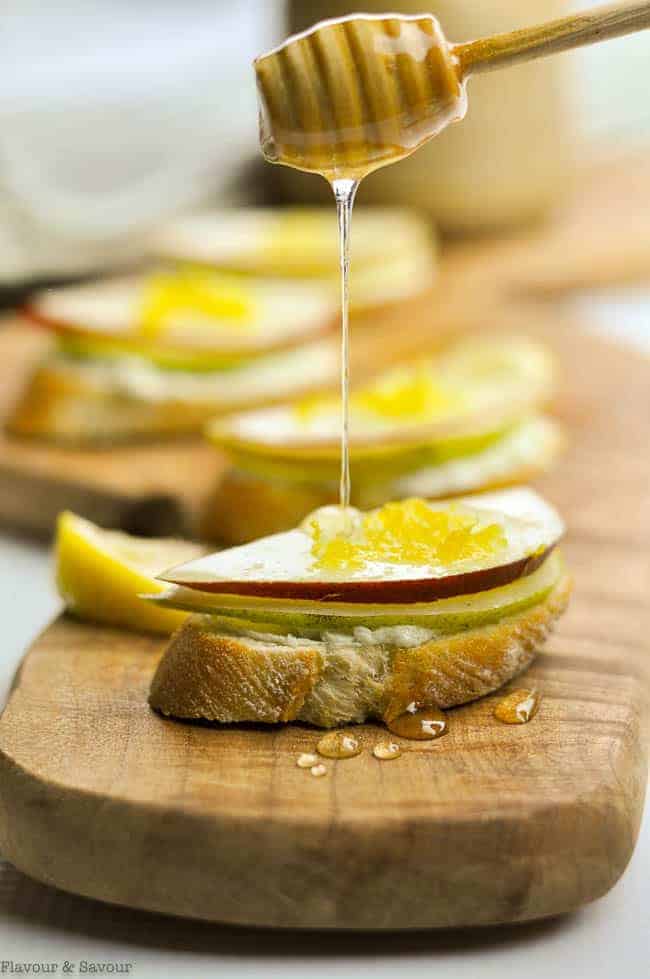 Drizzling honey on Blue Cheese and Pear Crostini