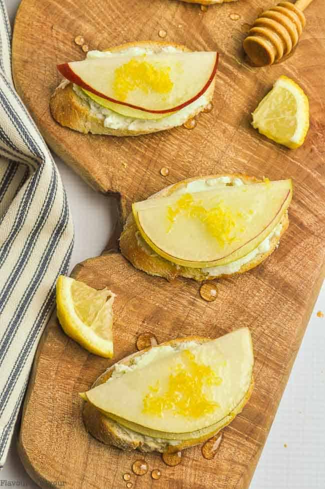 Blue Cheese and Crisp Honeyed Pear Crostini on a wooden serving board