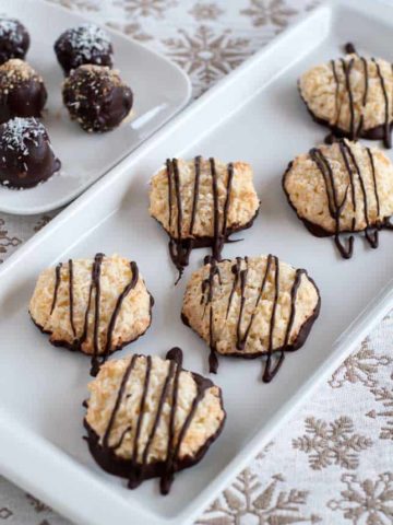 These gluten-free Chocolate Dipped Crispy Coconut Cookies are coated and drizzled with a tin layer of dark chocolate. Make ahead and freeze for unexpected company. |www.flavourandsavour.com