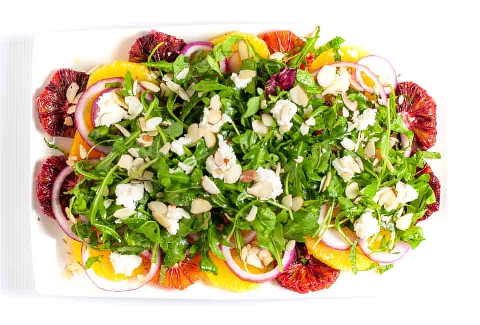 Winter Citrus Salad with Arugula and Goat Cheese. Sweet oranges, fresh mint and spicy arugula topped with tangy cheese and flaked almonds make a beautiful winter salad. One of 6 Tasty Healthy Winter Salads from Flavour and Savour.