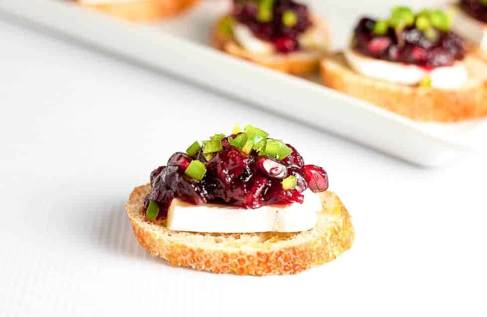 These Cranberry Jalapeño Brie Crostini Appetizers add a festive touch to your party and they're a great way to use leftover cranberry sauce! |www.flavourandsavour.com