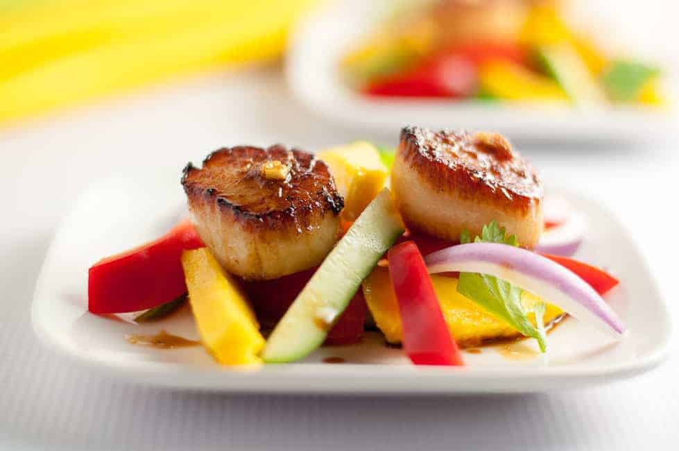Seared Scallops with Mango Salad.Discover three simple steps to create perfectly seared scallops, and serve them on a colourful salad made with thinly sliced mango, red pepper, cucumber and red onion.