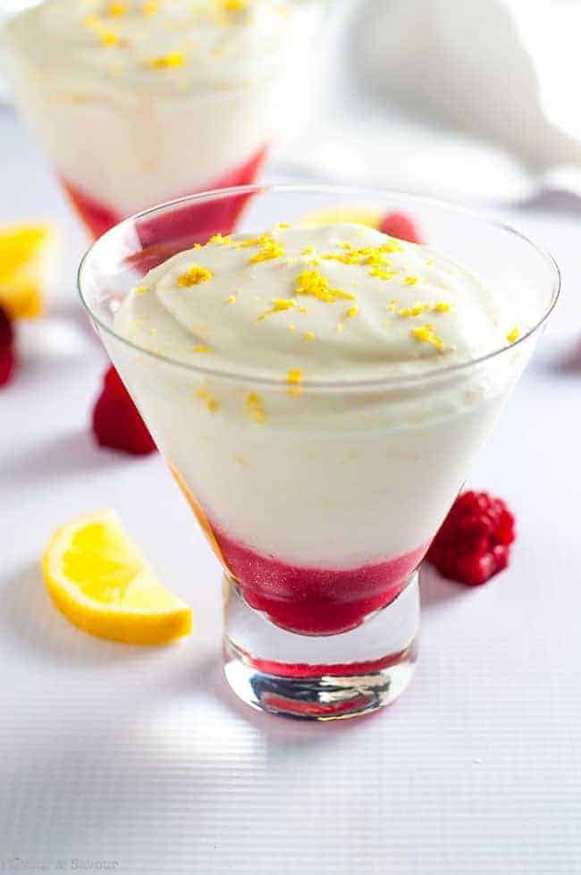 Light Lemon Mousse with Raspberry Sauce in dessert cups garnished with lemon zest. One of 15 Spring Brunch Recipe Ideas by Flavour and Savour