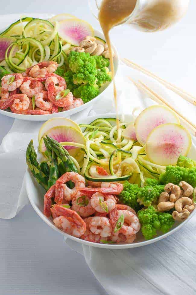 Grilled shrimp, raw zucchini noodles and crisp vegetables all drizzled with an intensely flavourful sesame miso vinaigrette make this Fresh Veggie and Grilled Shrimp Zoodle Bowl a nutritious lunch or a light dinner