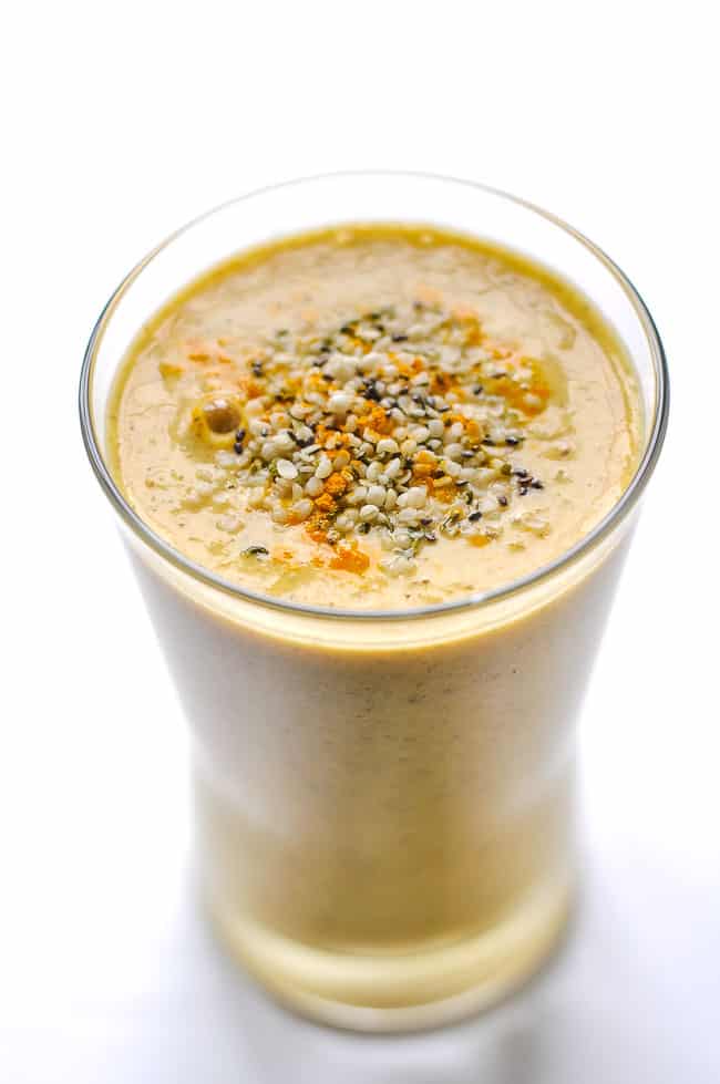 Tropical Turmeric Smoothie in a glass garnished with hemp and chia seeds